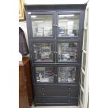 A modern washed charcoal coloured cabinet bookcase, comprising three pairs of glazed,