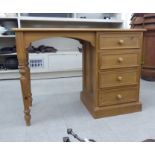 A modern pine single pedestal desk with four drawers,