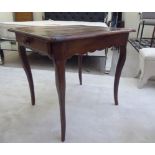 A late 19thC French country made cherrywood and walnut table with an end drawer,