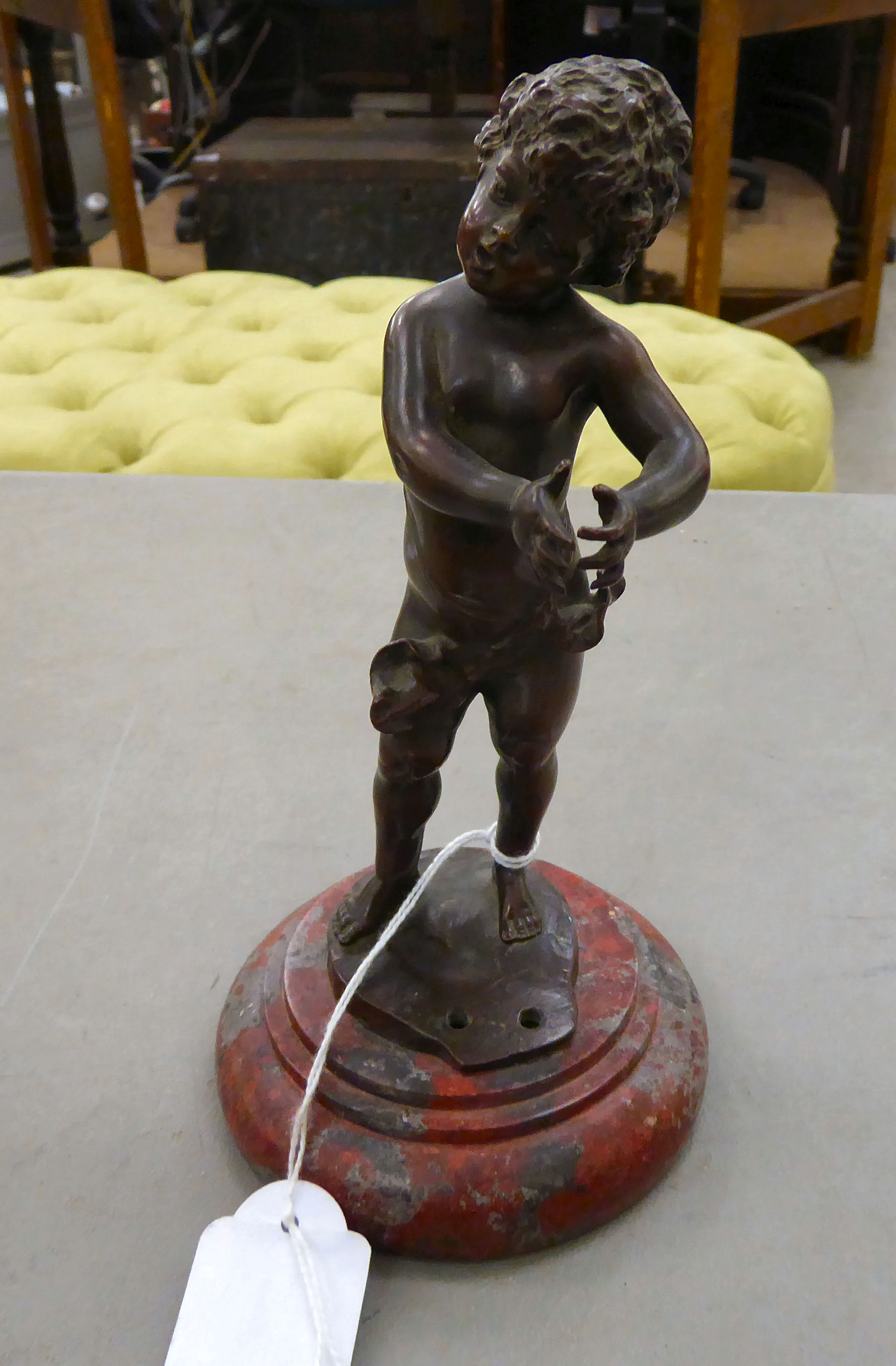 Franz Ifland - a cast and patinated bronze, a standing cherubic figure, on a turned,