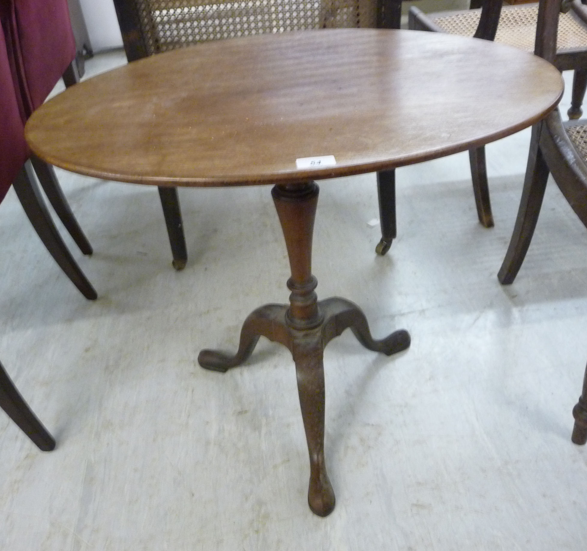 A mid 19thC and later mahogany pedestal table, the oval top over a tapered vase column,