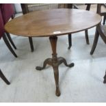 A mid 19thC and later mahogany pedestal table, the oval top over a tapered vase column,