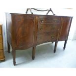 A 1920s mahogany concave front sideboard, the three graduated central doors with brass bail handles,