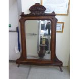 A late 19thC French bevelled ornamental mirror, set in a kingwood and carved oak frame,