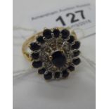 A 9ct gold diamond and sapphire set cluster ring 11