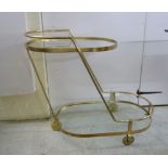 A modern gilded steel framed cocktail trolley with two plate glass tiers,