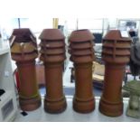 A set of four terracotta cylindrical chimney pots with ventilated tops 47''h SL