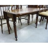 A mid Victorian mahogany Pembroke table, raised on ring turned,