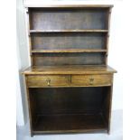 An early 20thC childs size stained oak dresser with a shelved superstructure,