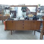 A mid 20thC Art Deco inspired rosewood and teak finished dressing table,