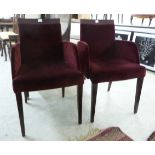 A pair of modern port wine coloured fabric upholstered, enclosed side chairs with level crests,