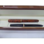 A Watermans 'red' fountain pen with a 9ct gold collar;