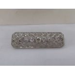 A white metal (possibly platinum) brooch,