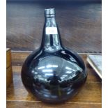 A late 19thC coloured glass bottle with a conical neck and bulbous body 14''h CA