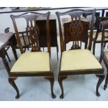 A pair of early 20thC Chippendale inspired mahogany framed dining chairs with yoke crests and