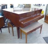 A Kemble lacquered mahogany cased boudoir grand piano, raised on square,
