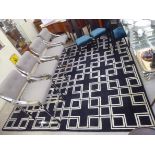 A modern wool carpet, decorated in white with geometric designs,
