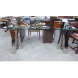 A modern centre table, the plate glass top elevated on square box section,