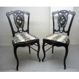 A pair of late Victorian black lacquered boudoir chairs with overpainted,