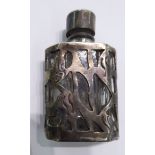 An 'antique' white metal and glass miniature perfume bottle with pierced,