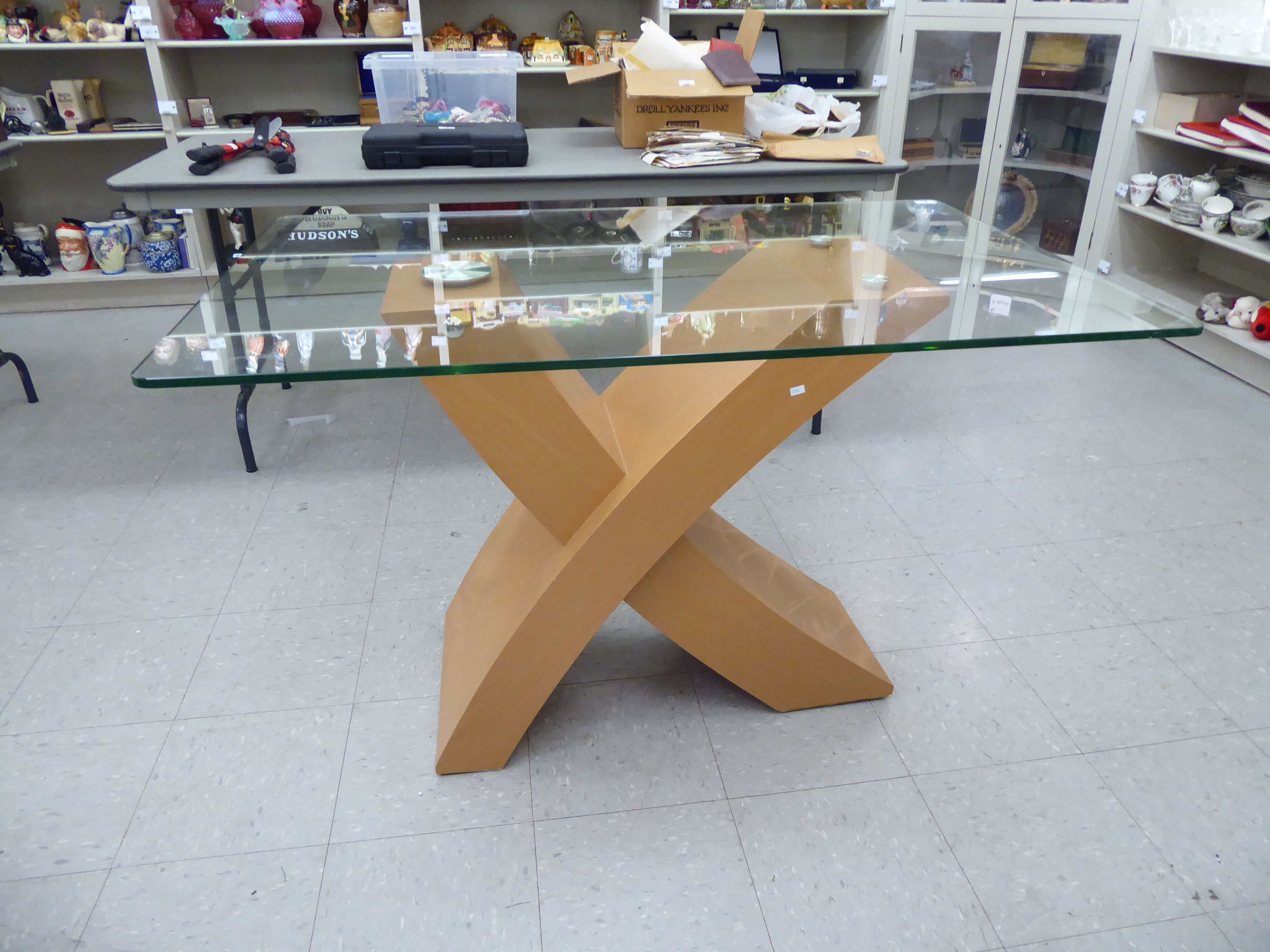 A modern centre table, the clear plate glass top elevated on a light coloured, beech finished, - Image 2 of 2