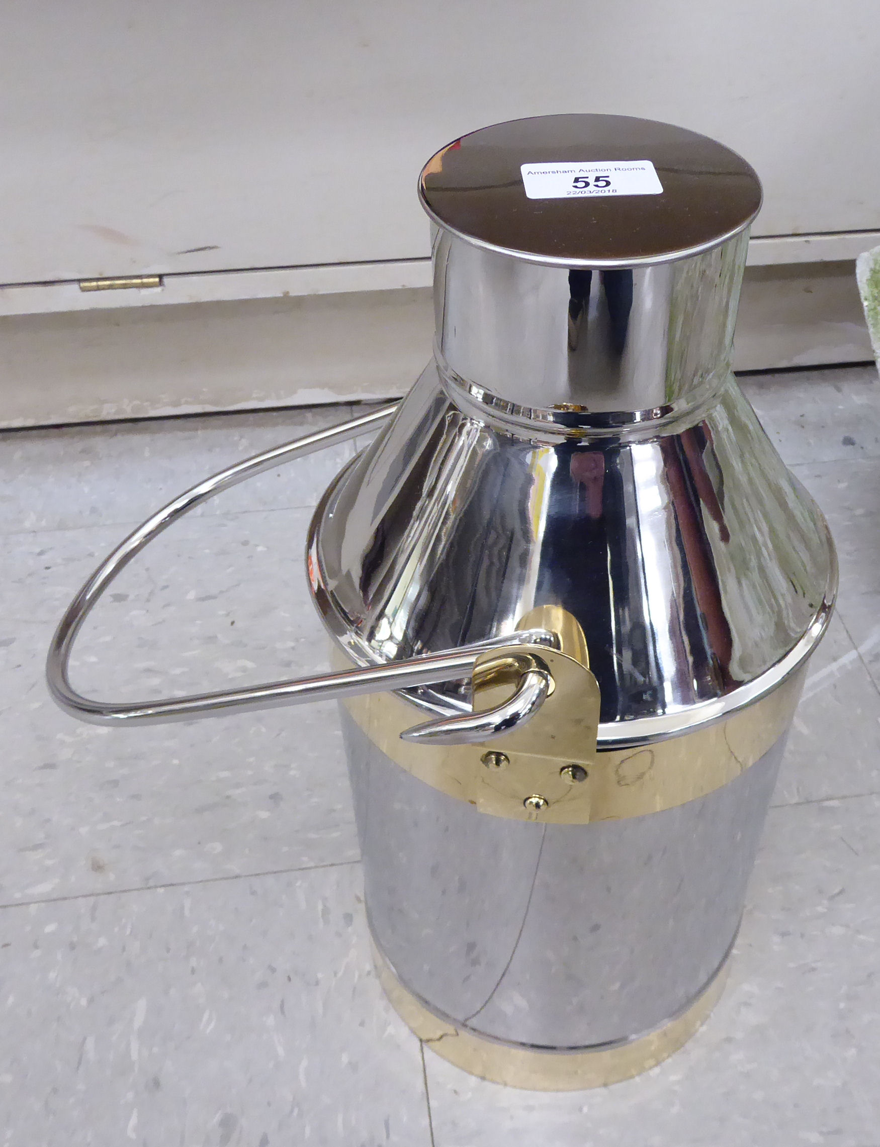 A modern stainless steel milk churn with a swing handle 16''h LAM