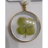 A 9ct gold and glazed pendant,