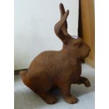 A modern rust finished cast iron model hare 14''h RAF