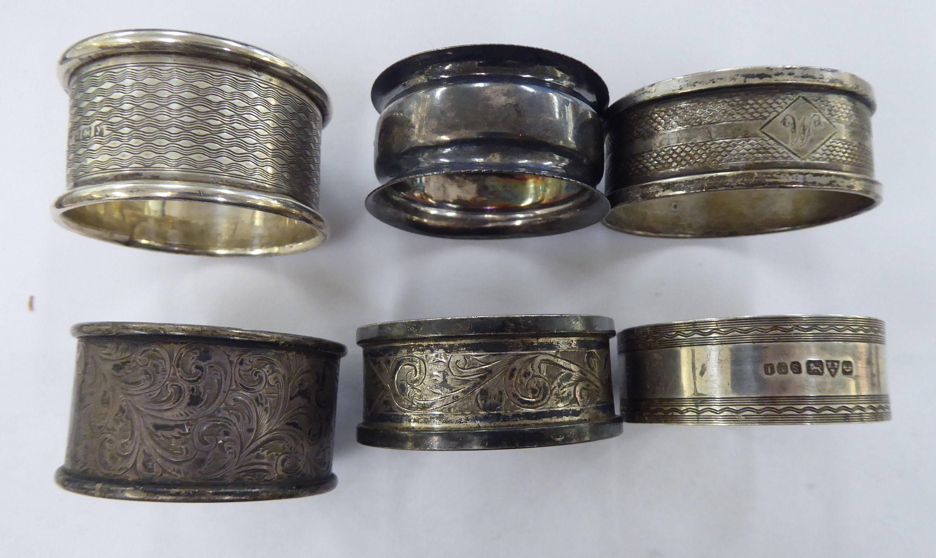 Six dissimilar silver napkin rings mixed marks 11