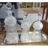 A presentation set comprising a graduated set of three cut-glass thistle design decanters and