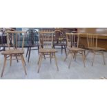 A set of four Ercol light stained beech and elm framed kitchen chairs with level,