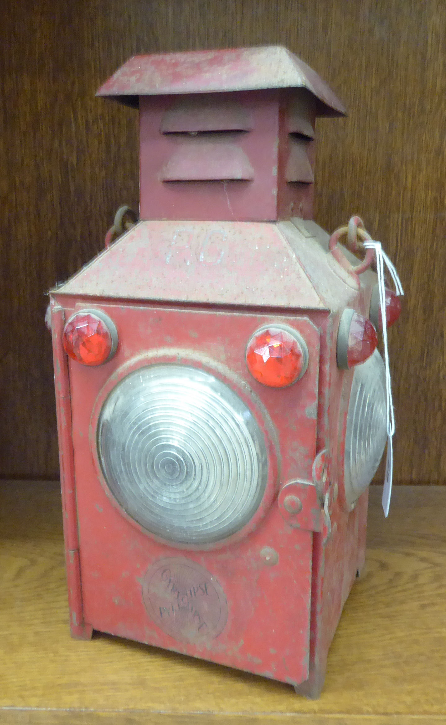 A Gyreclipse red painted tinplate railway lantern of box design with clear glass windows and red