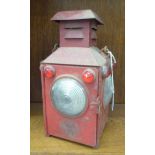 A Gyreclipse red painted tinplate railway lantern of box design with clear glass windows and red