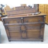 A mid 20thC Jaycee stained and carved oak dresser base with panelled flanks, two in-line drawers,