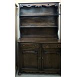 A mid 20thC dark oak cottage dresser with a shelved superstructure,