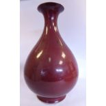 A 20thC Chinese sang du boeuf glazed porcelain bulbous bottle vase with a tapered,