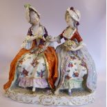 A 20thC Naples porcelain group, two seated young women wearing bonnets and floral skirts,