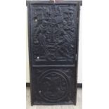 A 17thC blacked cast iron fireback, the upper part featuring two figures,