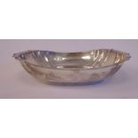 A silver dish of oval panelled form with an everted rim J Barraclough & Sons Sheffield 1922 7.