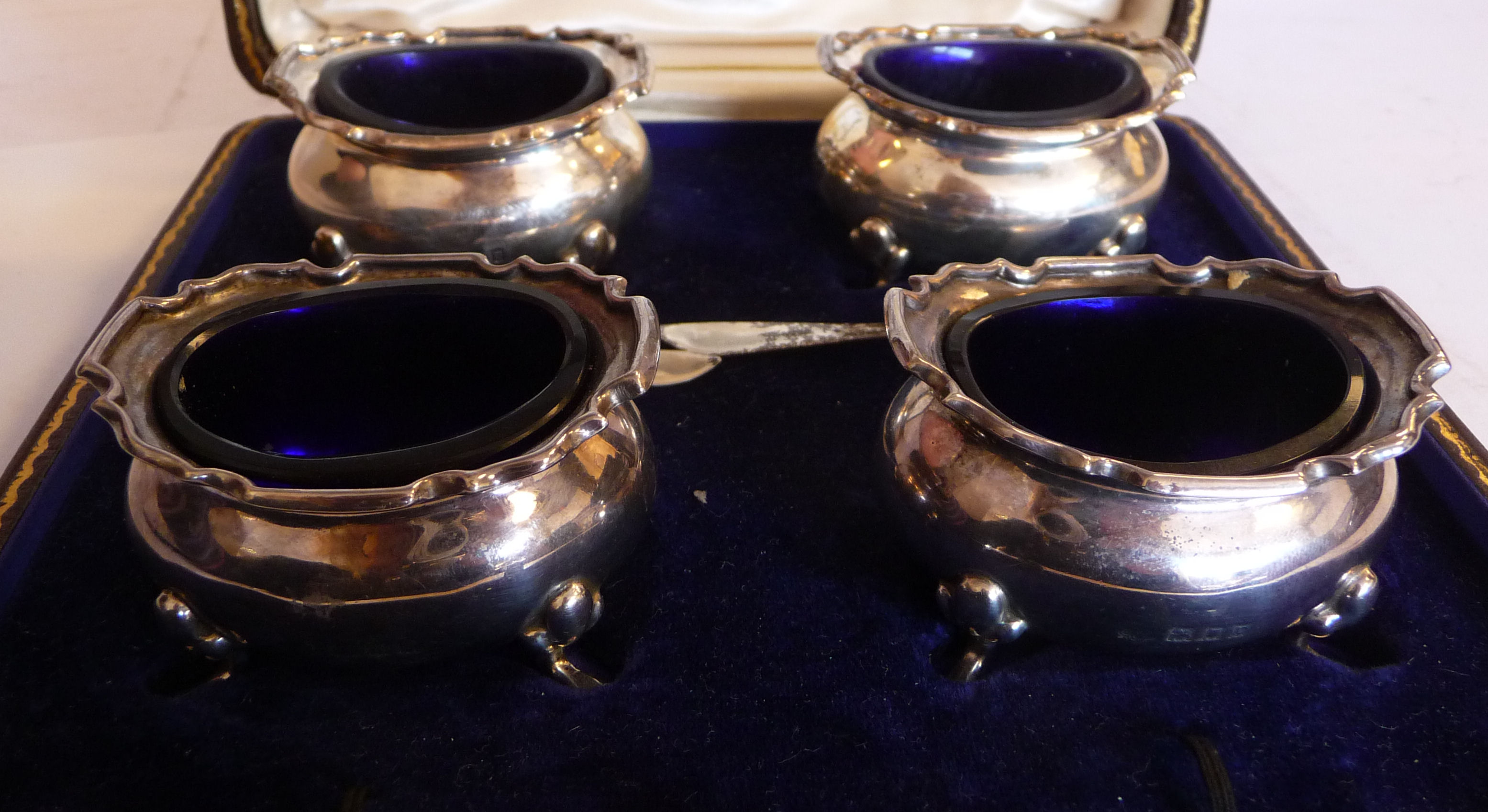 A set of four silver oval salt cellars of oval ogee form with flared,