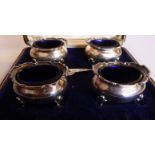 A set of four silver oval salt cellars of oval ogee form with flared,