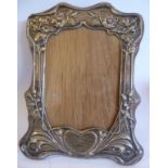 An Art Nouveau silver glazed photograph frame, embossed with flora,