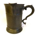 A late 18th/early 19thC pewter tankard jug of banded, tapered form with a flared lip,