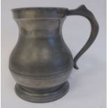 A mid 19thC pewter half gallon size measure of banded baluster form with an S-scrolled handle,