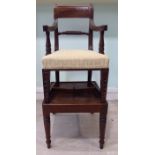 A child's late Georgian mahogany framed chair with a curved bar crest and swept, open arms,