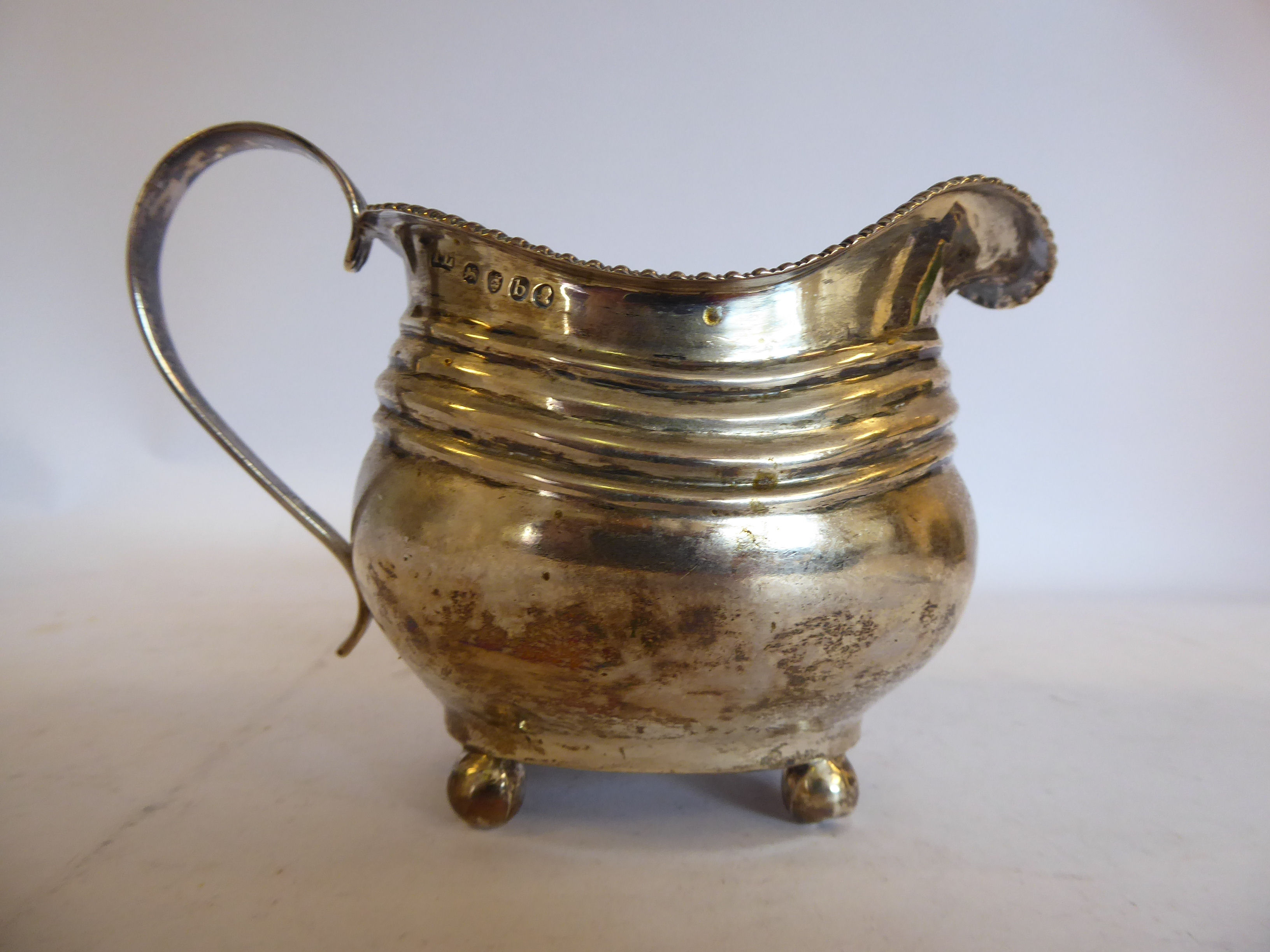 A George III silver cream jug of oval,