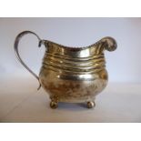 A George III silver cream jug of oval,