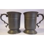 A pair of Victorian half-pint size pewter tankards with banded decoration,