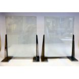 A pair of Art Deco photograph frames, each comprising two clear glass panels,