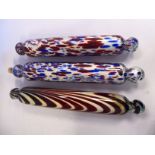 Three similar late 19thC blown glass rolling pins with Nailsea style multi-coloured splashed and